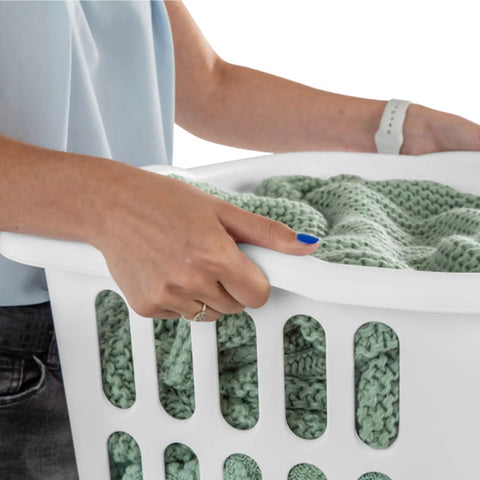 Person holding a 12 Pack Rectangular Laundry Basket with Handles, Heavy Duty Plastic Hamper, 1.5 Bushel Capacity, White Laundry Organizer