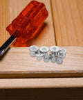 Eight Piece Pro Grade Metal Doweling Center Pins And Dowel Locator Plugs For Woodworking Drill Alignment, shown on wood surface.