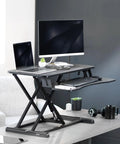32 Inch Desk Converter K Series Sit To Stand Riser With Dual Monitor And Laptop Workspace Height Adjustable Standing Desk Attachment Wide Keyboard Tray Black DESK V000K with monitors and a laptop on a raised surface.