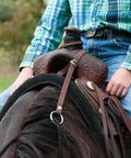 Close-up of adjustable bungee rein attached to saddle, showing waterproof polypropylene construction and carabiner O-ring.