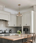 Straight Up Vintage Amber Glass Pendant Light With Ridiculously Smooth Adjustable Hanging Cord And Killer Floral Design For That Total Glow Up Look You Always Wanted hanging in a modern kitchen above a wooden table.