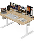 Wide 55x32 Inch Electric Standing Desk With Height Adjustment, 2 Memory Presets, 31.5 Inch Deep Work Surface, Sit Stand Home Office Desk With Hooks, Oak Finish shown with monitors, laptop, and accessories