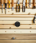 TOKIDNY Pneumatic Wire Crimping Machine With Advanced Pressure Control And Durable Metal Dies For Electrical Communication Work Universal Attachments Maximize Efficiency Heavy Duty Industrial Tool displayed with various hand tools on wooden wall.
