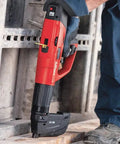 Worker using powder actuated fastener cartridge for concrete and steel, .27 caliber, short 6.8/11 mm, on construction site