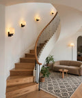 Modern Black Milk Glass Wall Sconces, 1 Pack Hardwired Wall Light Fixtures illuminating a stylish staircase interior.