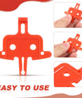 4 Pack Bicycle Disc Brake Spacers shown in orange plastic, lightweight pad spacers for hydraulic disc brakes, close-up detail.