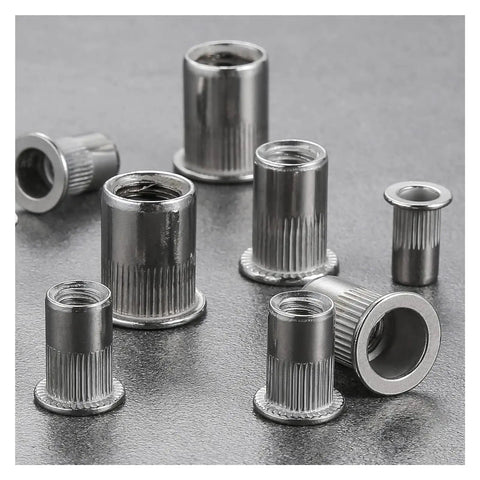 Close-up of Twenty Pieces 304 Stainless Steel Flat Head Threaded Inserts With Knurled Body for Heavy Duty Metal Work.