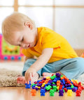 Child playing with Hella Cool Big Time 120 Piece Math Manipulatives Counting Bear Set With Vibrant Six Color Blocks.