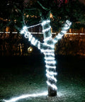 50FT 360 LED Waterproof Rope Lights 110V Connectable Indoor Outdoor White LED Rope Lights For Deck Patio Pool Landscape Lighting With Easy Install Screws And Clamps wrapped around a tree at night