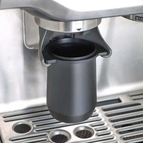 54mm Dosing Cup for Breville 54mm Portafilters and Home Espresso Rigs Fits Barista Express Pro Barista Touch Smart Grinder Niche Zero and Other 54mm Breville Machines Black shown under espresso machine.