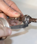 Applying nickel anti seize lubricant 2400°F to metal component for high-temperature protection and copper-free performance.