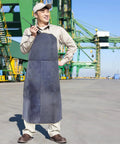 Person wearing Pro Grade Cowhide Welding Apron Heat Resistant Shield For Sparks And Splatter Fireproof Soldering Gear outdoors