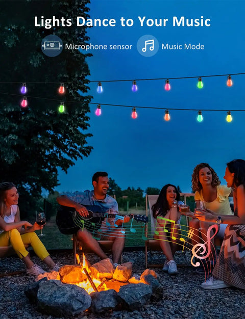 People enjoying a campfire under 48Ft RGB Outdoor String Lights With 15 Dimmable LEDs, App Control And Music Sync, IP67 Waterproof.