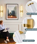 Close-up of modern wall sconce details with acrylic lampshade and brushed metal base, LED light source.