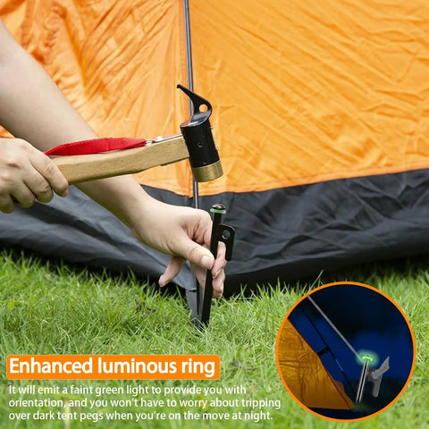 Person hammering Heavy Duty 8 Inch Tent Stakes Set With Metal Pegs Fluorescent Silicone Rings And Storage Bag For Camping into grass