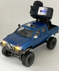 Beefed Up 1/16 Scale RC Rock Crawler With 4x4 Drive All Terrain Off Road Pickup shown with 2.4GHz radio and detailed blue twin-cab design