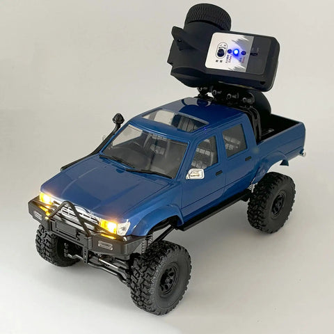 Beefed Up 1/16 Scale RC Rock Crawler With 4x4 Drive All Terrain Off Road Pickup shown with 2.4GHz radio and detailed blue twin-cab design