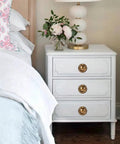White dresser with 8 Pack 2 Inch Antique Brass Ring Drawer Pulls With Round Plate Base for Cabinets and Cupboards in bedroom setting.