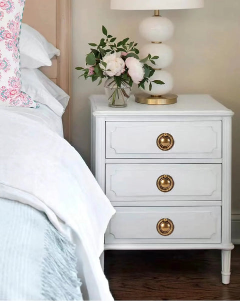 White dresser with 8 Pack 2 Inch Antique Brass Ring Drawer Pulls With Round Plate Base for Cabinets and Cupboards in bedroom setting.