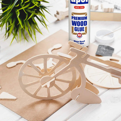 Go-To Water Resistant Wood Glue 16 Oz Two Pack Clear PVA Adhesive with wooden bicycle model for woodworking projects.