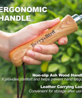 Hand holding Seed Dibber Tool With Measuring Scale And Stainless Steel Tip Wooden Handle For Precise Seed Planting Transplants Bulbs And Small Plants Ideal For Narrow Beds And Tight Spots Heavy Duty Garden Trowel showing ergonomic wooden grip