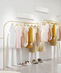 Sturdy Gold Iron Wall Mounted Clothing Rack 300cm for Garments and Shoes in room setting with clothes hanging by hangers