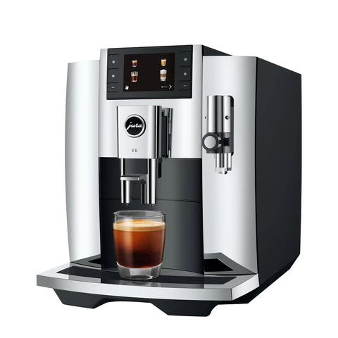 Fully Automatic Chrome Espresso Machine One Touch Custom Barista Brewer Fresh Bean Grinder Premium Coffee Maker Top Shelf Brewmaster with espresso in glass.