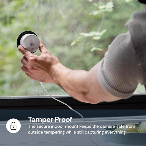 Person installing 3MP 2K Window Camera With Color Night Vision AI Motion Alerts And Easy Stick On Glass Angled Mount For Home Security