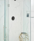 Align One-Function Eco-Performance Fixed Showerhead in matte black installed in modern bathroom with glass shower enclosure.