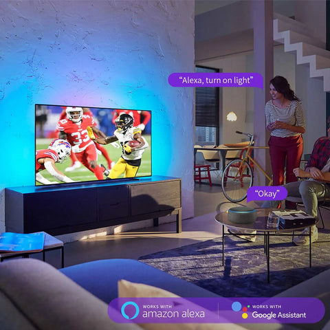 Living room with Chill USB TV Backlight Strip for 60 to 72 Inch TVs, glowing blue with Alexa voice control shown on screen.