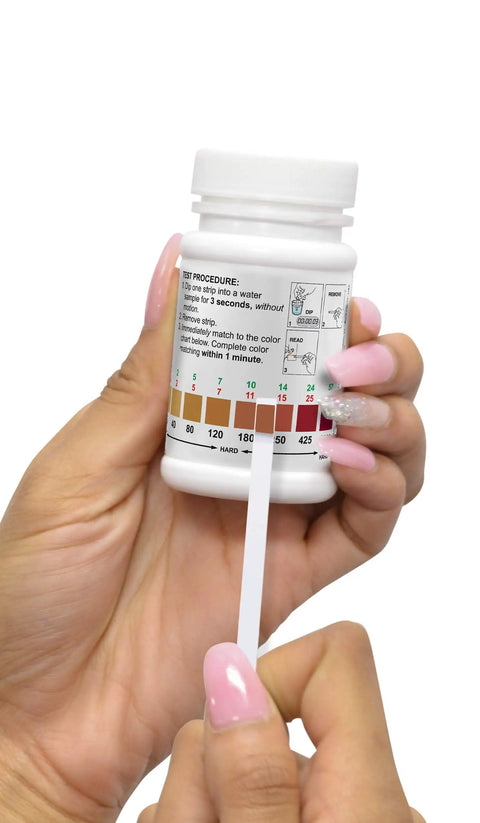 Water Hardness Test Strip 0-1000 PPM, 3-Second Quick Dip Read Kit With Tan Color Chart, Bottle Of 50 Tests, Easy For Home Or Tech Water Testing Of Total Hardness held in hand