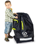 Child standing next to black Car Seat Travel Bag For Airplane With Dual Carrying Straps Gate Check Ready Durable Car Seat Cover