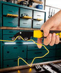 Super Durable Manual Wire Straightener Tool held in hand, aligning yellow wire with precision in a workshop.