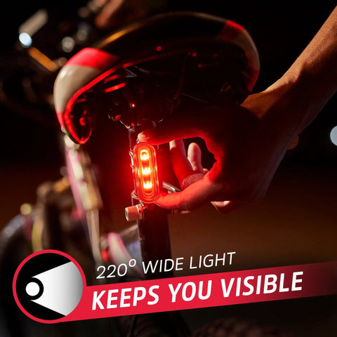 Person attaching rear light from Front And Rear Bike Light Set With Batteries Included, 220 Degree Rear Light For Wide Visibility