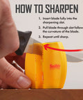 Using Two Step Knife Sharpener with Coarse and Fine Slots, yellow, portable tool on a knife, close-up of sharpening action.