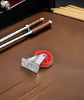 Hella Smooth Nylon Caster Wheels For Mechanic Creepers Providing Straight Up Quiet Rollout And Rock Solid Swivel Control For Effortless Shop Floor Cruising on a brown leather surface.