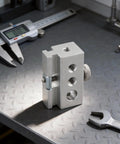 Super Slick Silver Aluminum Camping Table Clip Slider Igt Compatible Multi Hole Adapter For 6Mm 8Mm And Quarter Inch on a workbench.