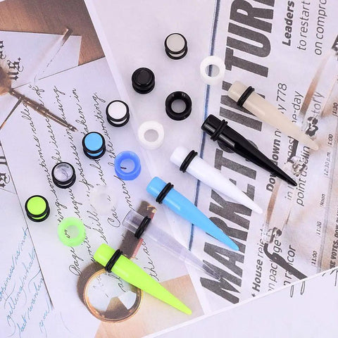 Dope Ear Stretching Kit With Acrylic Tapers And Silicone Tunnels, 36 Pieces 00G To 20mm, mixed colors on a paper background