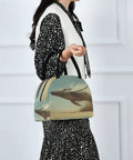 Woman holding Whale Desert Jump Insulated Lunch Bag For Women Men with full-body whale print design and easy carry handle