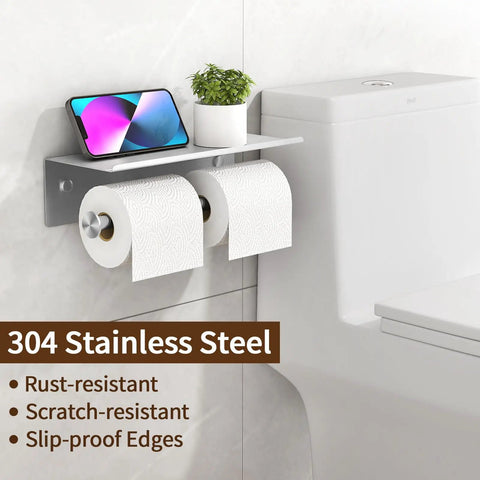 Heavy Duty Wall Mounted Double Toilet Paper Holder With Shelf In Brushed Nickel Stainless Steel Dual Roll Dispenser And Flushable Wipes Dispenser No Fuss Bathroom Storage Solution attached to wall with phone and plant on shelf.