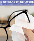 Eyeglasses anti-fog wipes used on black frames; close-up view.