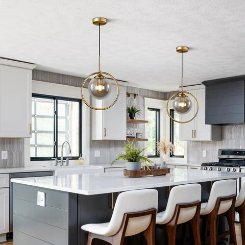 Dope Smoke Gray Glass Globe Pendant Light With Gold Rim above a modern kitchen island, large minimalist ceiling fixture.