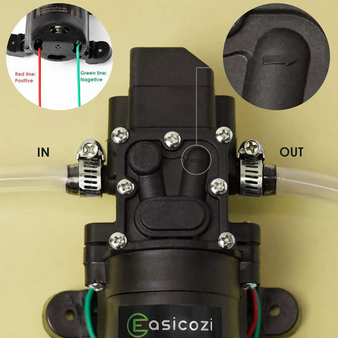 12 Volt Fresh Water Pump For RV Camper Boat And Lawn With Self Priming Diaphragm, close-up of inlet and outlet with hose clamps.