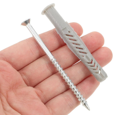 Drywall Anchor Kit With Zinc Plated Screws For Hollow Walls 20 Pieces Easy Install Sheetrock Anchors For Secure Mounts Ideal For Shelves Mirrors And Decor. Gray anchor and zinc screw in hand