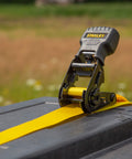 One Inch By Ten Foot Ratchet Tie Down Straps on truck bed, 500 Pound Safe Working Load, Black and Yellow, Quick Grab Handle visible