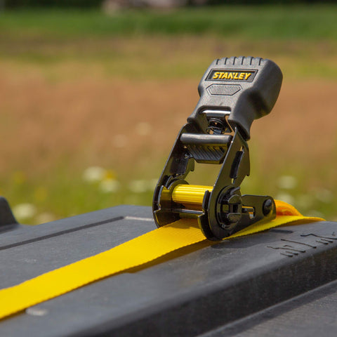 One Inch By Ten Foot Ratchet Tie Down Straps on truck bed, 500 Pound Safe Working Load, Black and Yellow, Quick Grab Handle visible