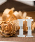 No Sweat Furniture Assembly Hardware 50 Piece Clamp Nut And Connecting Screw Kit on wooden backdrop with shavings.