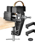 Heavy Duty Cast Steel Bench Vise Two Inch Jaw Clamp holding a gold ring on a wooden table, compact clamping for jewelry tasks.
