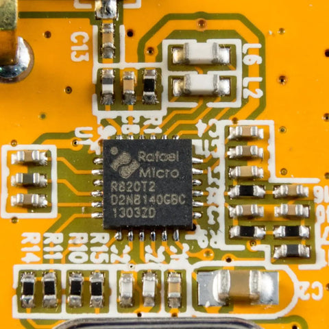 Close-up of an R820T2 tuner chip on a circuit board, part of the Budget USB RTL SDR And ADS B Receiver Kit with R820T2 tuner MCX input.