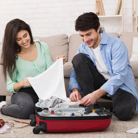Couple using 180 Piece Cable Ties Kit With 4 6 8 10 Inch Reusable Nylon Ties In Crazy Colorful Hues to organize suitcase cables